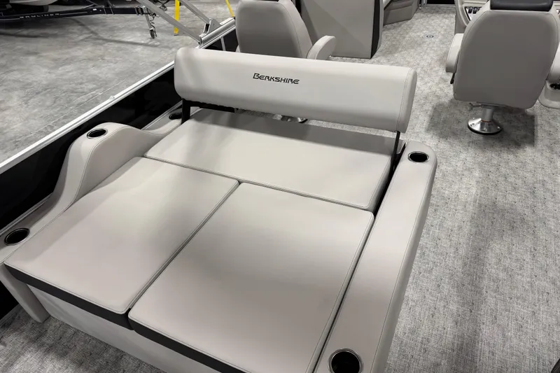 Slide: The Image of 2026 Berkshire 24 UL LE boat interior with plush seating and cup holders. - 13