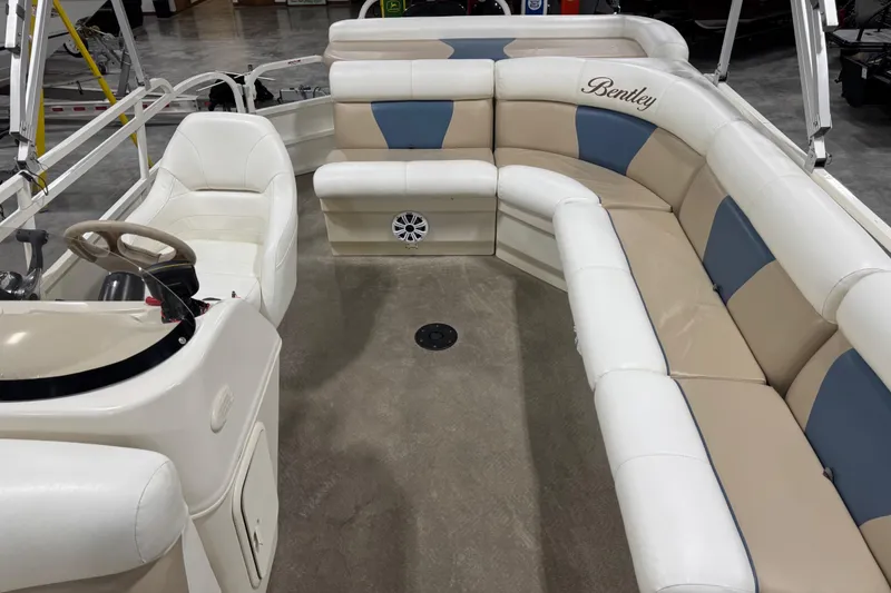 Slide: The Image of 2008 Bentley Pontoons 243 Cruise interior with plush seating and steering console. - 10