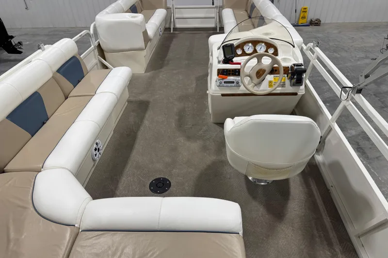 Slide: The Image of 2008 Bentley Pontoons 243 Cruise interior with white seating and steering console. - 8