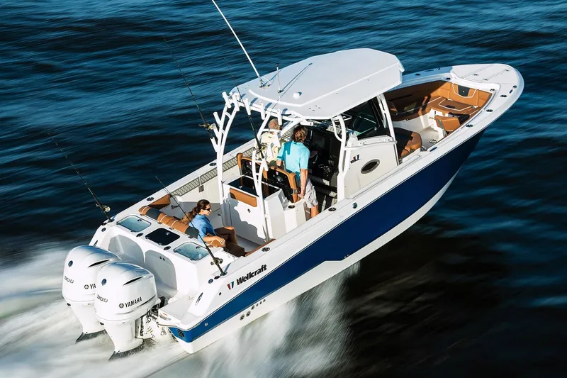 The Image of 2019 Wellcraft 302 Fisherman boat docked, featuring a sleek blue and white design. - 0