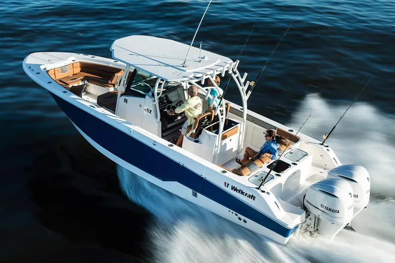 Slide: The Image of 2019 Wellcraft 302 Fisherman boat docked with twin Yamaha engines. - 1