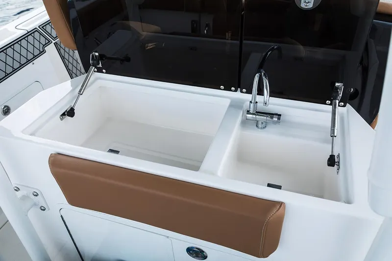 Slide: The Image of 2019 Wellcraft 302 Fisherman boat interior with seating and storage, docked at marina. - 12
