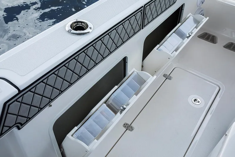 Slide: The Image of 2019 Wellcraft 302 Fisherman boat docked at a marina, showcasing its spacious deck. - 13