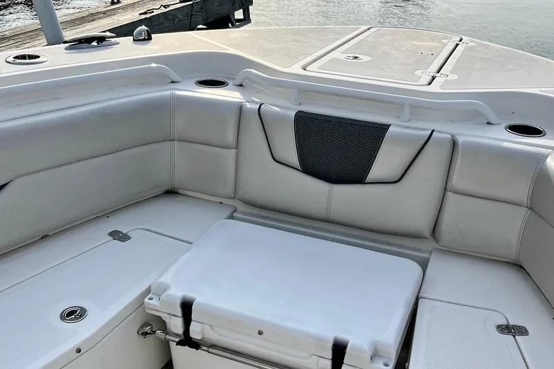Slide: The Image of 2019 Wellcraft 302 Fisherman boat interior with cushioned seating and storage compartments. - 18