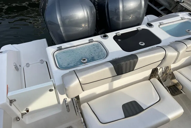 Slide: The Image of 2019 Wellcraft 302 Fisherman boat with dual engines and seating area. - 19