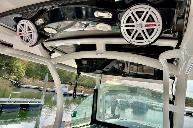 Slide: The Image of 2019 Wellcraft 302 Fisherman boat interior with JL Audio speakers and scenic marina view. - 20