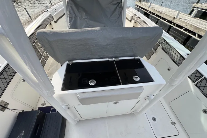 Slide: The Image of 2019 Wellcraft 302 Fisherman boat interior with covered console and storage compartments. - 21