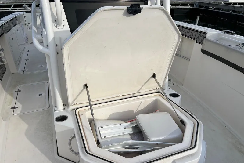 Slide: The Image of 2019 Wellcraft 302 Fisherman boat with open storage compartment on deck. - 22