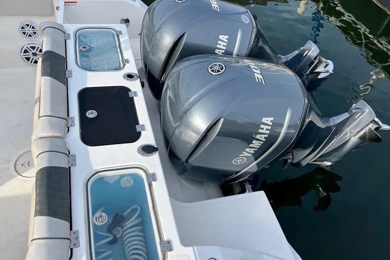 Slide: The Image of 2019 Wellcraft 302 Fisherman with dual Yamaha outboard engines and livewell compartments. - 24