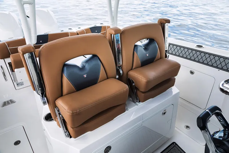 Slide: The Image of 2019 Wellcraft 302 Fisherman boat dashboard with steering wheel and navigation controls. - 9