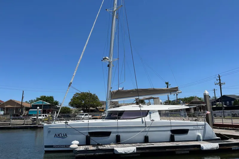 Slide: The Image of 2018 Fountaine Pajot Helia 44 Evolution catamaran docked under clear blue sky. - 0