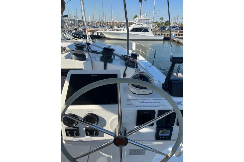 Slide: The Image of 2018 Fountaine Pajot Helia 44 Evolution catamaran docked, showcasing sleek design and spacious deck. - 1