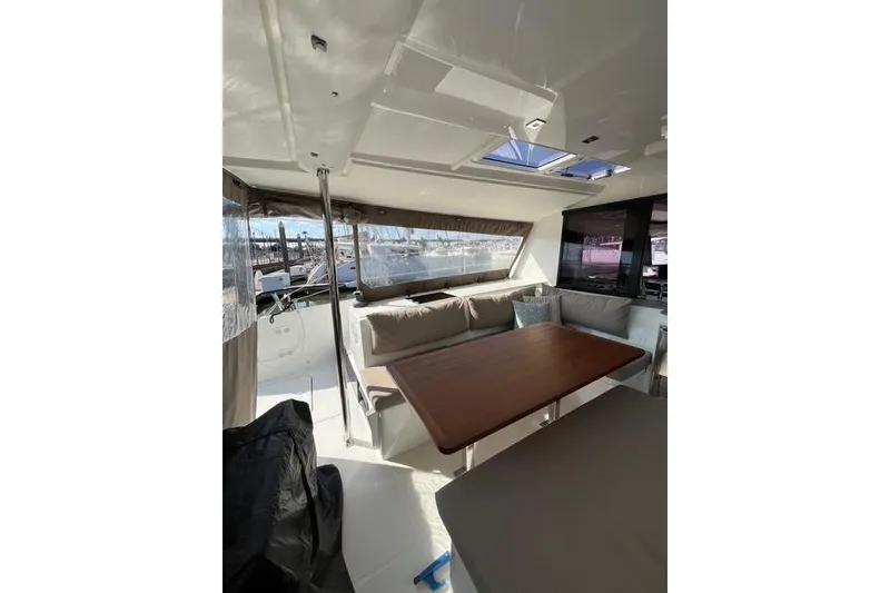 Slide: The Image of 2018 Fountaine Pajot Helia 44 Evolution yacht interior with dining area and large windows. - 22