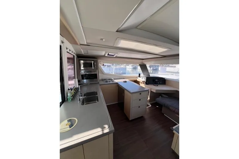 Slide: The Image of Interior of 2018 Fountaine Pajot Helia 44 Evolution catamaran, featuring modern kitchen and navigation area. - 27