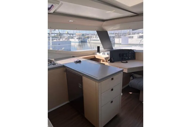Slide: The Image of Interior of 2018 Fountaine Pajot Helia 44 Evolution catamaran, featuring modern kitchen and navigation area. - 35
