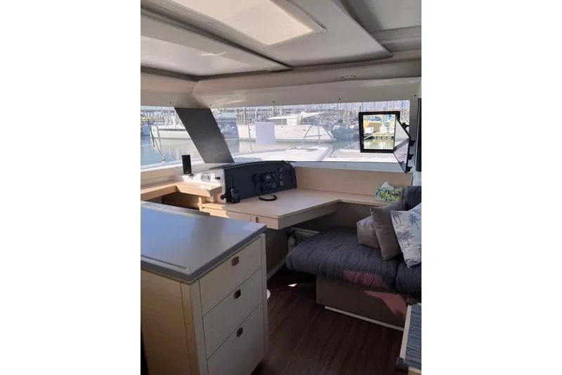 Slide: The Image of Interior of 2018 Fountaine Pajot Helia 44 Evolution catamaran, featuring navigation station and seating area. - 36