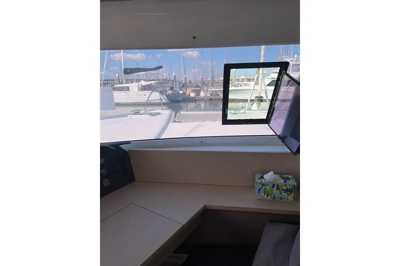 Slide: The Image of Interior view from a 2018 Fountaine Pajot Helia 44 Evolution catamaran, overlooking a marina. - 45
