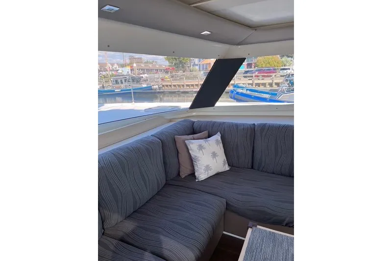 Slide: The Image of Interior of 2018 Fountaine Pajot Helia 44 Evolution with cozy seating and decorative pillows. - 47