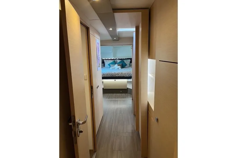 Slide: The Image of Interior hallway of 2018 Fountaine Pajot Helia 44 Evolution catamaran, leading to a cozy bedroom. - 56