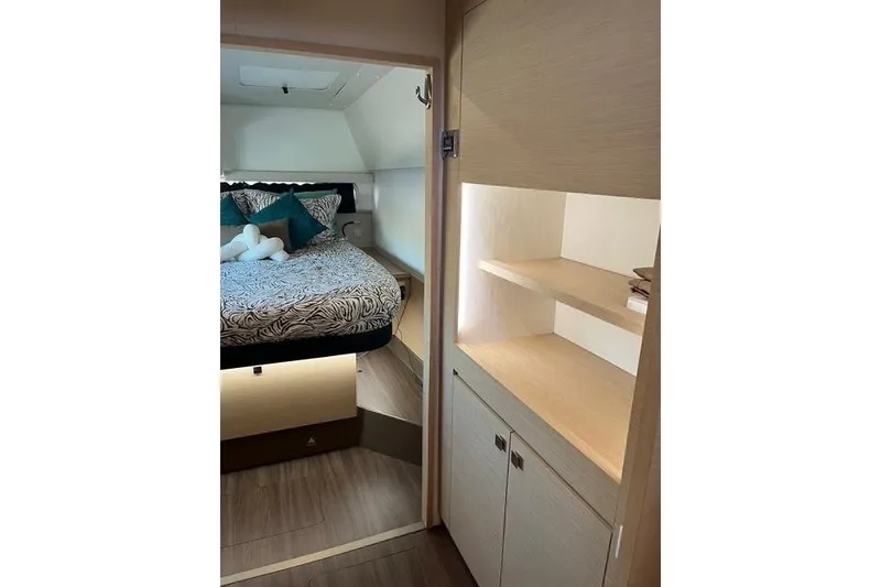 Slide: The Image of Interior of 2018 Fountaine Pajot Helia 44 Evolution catamaran, featuring cozy bedroom and storage. - 57
