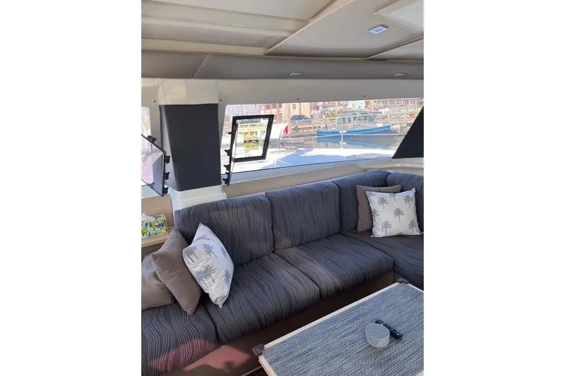 Slide: The Image of Interior of 2018 Fountaine Pajot Helia 44 Evolution yacht with cozy seating and scenic window view. - 64