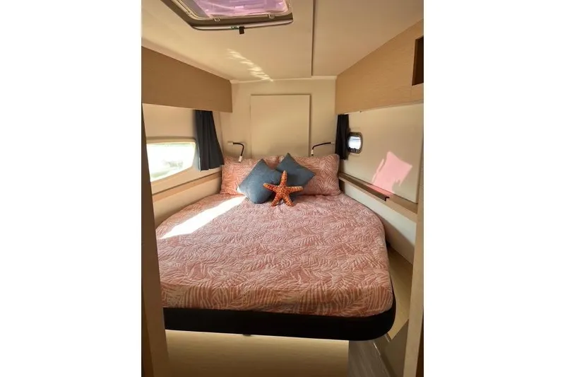 Slide: The Image of 2018 Fountaine Pajot Helia 44 Evolution cabin with cozy bed and decorative pillows. - 68