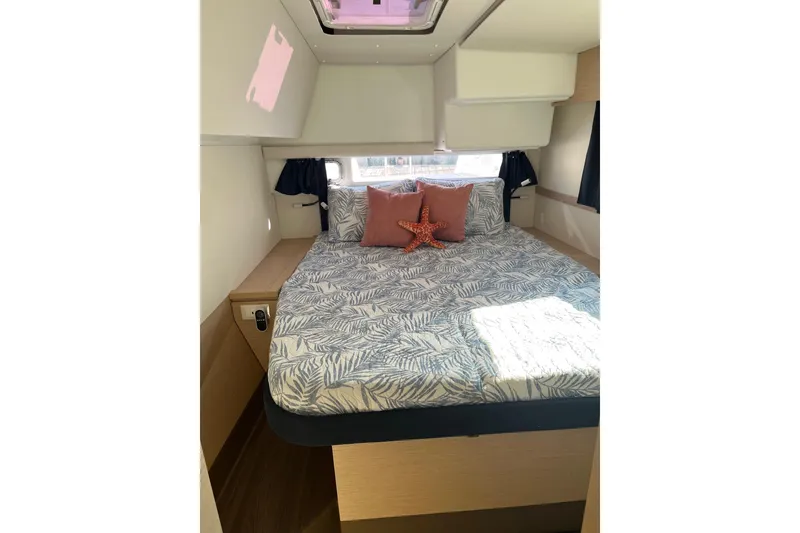 Slide: The Image of 2018 Fountaine Pajot Helia 44 Evolution yacht interior with cushioned seating and marina view. - 7