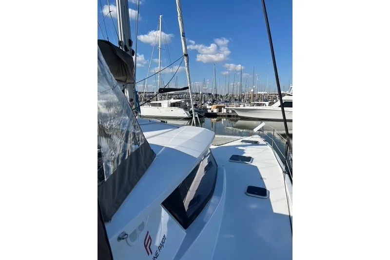 Slide: The Image of 2018 Fountaine Pajot Helia 44 Evolution catamaran docked in a marina under blue skies. - 72