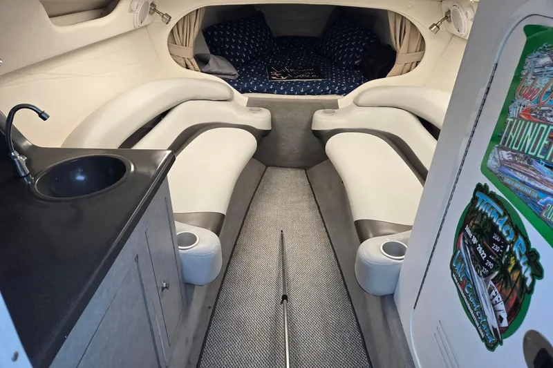 Slide: The Image of Interior of 2003 Baja 33 Outlaw boat with seating, sink, and cabin area. - 10