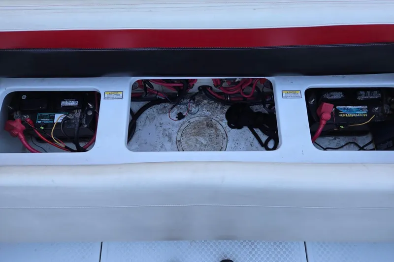Slide: The Image of 2003 Baja 33 Outlaw boat battery compartment with wiring and connections. - 11