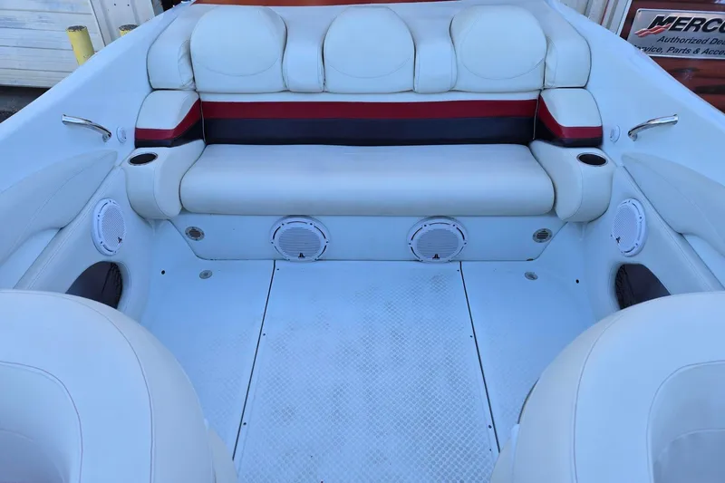 Slide: The Image of 2003 Baja 33 Outlaw boat interior with white seating and built-in speakers. - 14