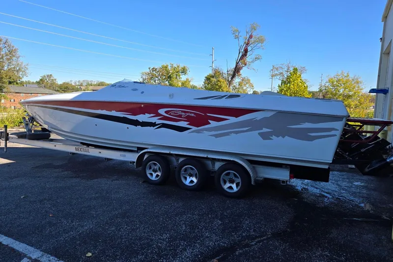 Slide: The Image of 2003 Baja 33 Outlaw speedboat on trailer, featuring sleek design and vibrant graphics. - 4