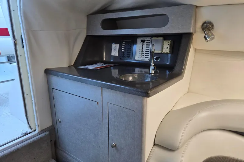 Slide: The Image of 2003 Baja 33 Outlaw boat interior with sink and control panel. - 9