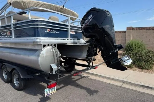 Slide: The Image of 2023 Sun Tracker Fishin' Barge 20 DLX on trailer with Mercury outboard motor. - 3