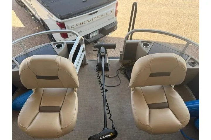 Slide: The Image of 2023 Sun Tracker Fishin' Barge 20 DLX with beige seats and a trolling motor. - 4