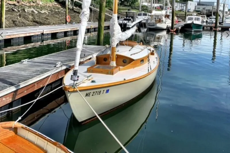 Slide: The Image of Vintage 1950 Mason Ostkust Sloop docked at a marina, reflecting on calm water. - 2