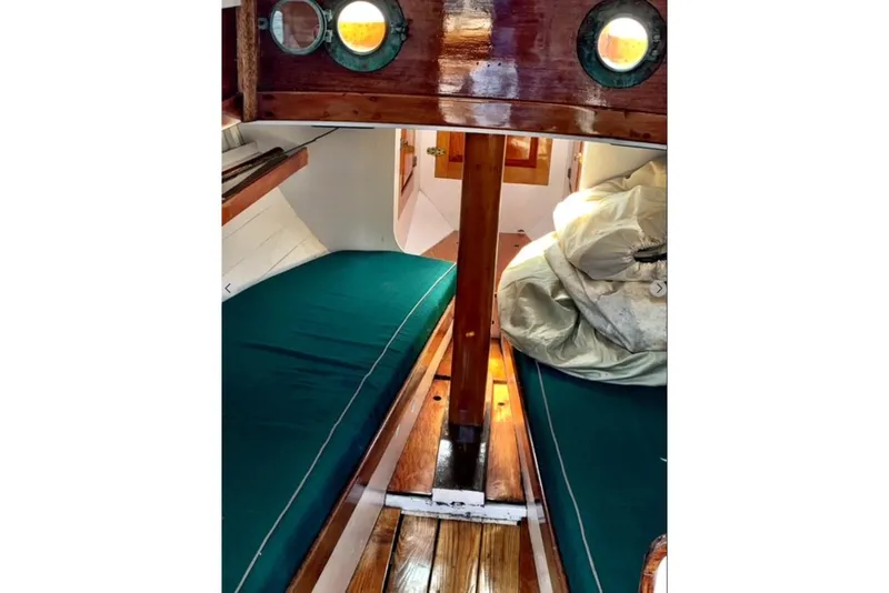 Slide: The Image of Interior of 1950 Mason Ostkust Sloop with wooden finish and green cushions. - 5