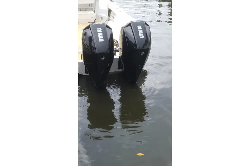 Slide: The Image of Twin Mercury outboard motors on a 1989 Mako 260 Walk Around boat. - 10