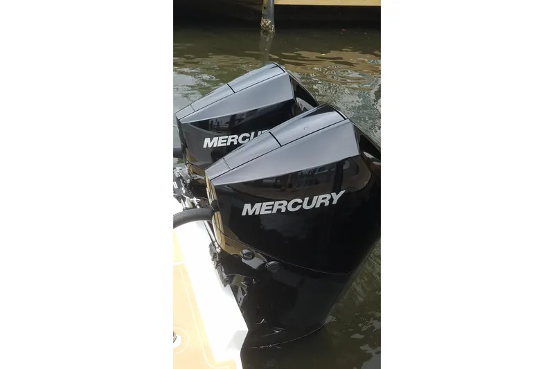 Slide: The Image of Twin Mercury outboard engines on a 1989 Mako 260 Walk Around boat. - 11