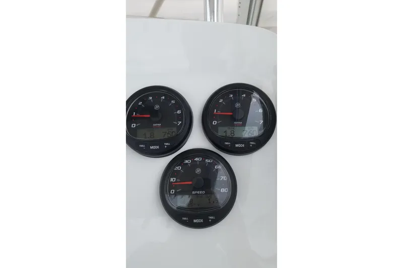 Slide: The Image of Close-up of gauges on a 1989 Mako 260 Walk Around boat dashboard. - 7