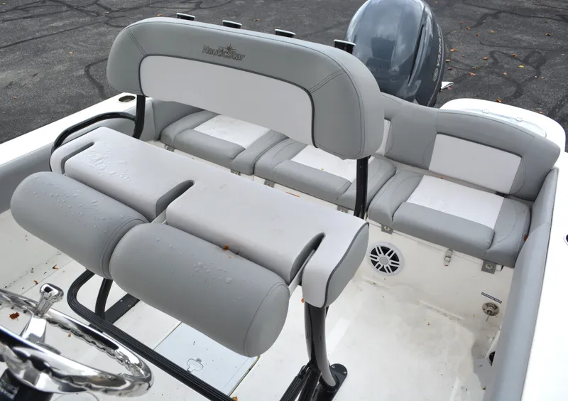 Slide: The Image of 2023 NauticStar 2102 Legacy boat interior with gray seating and steering wheel. - 13