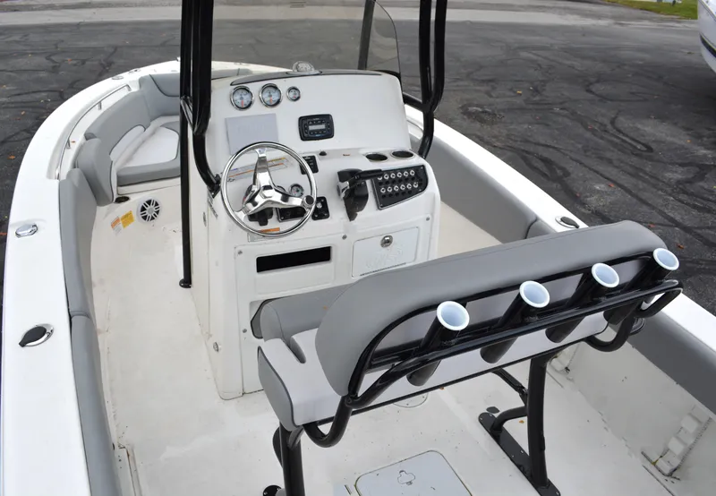 Slide: The Image of 2023 NauticStar 2102 Legacy boat interior with steering console and seating. - 5