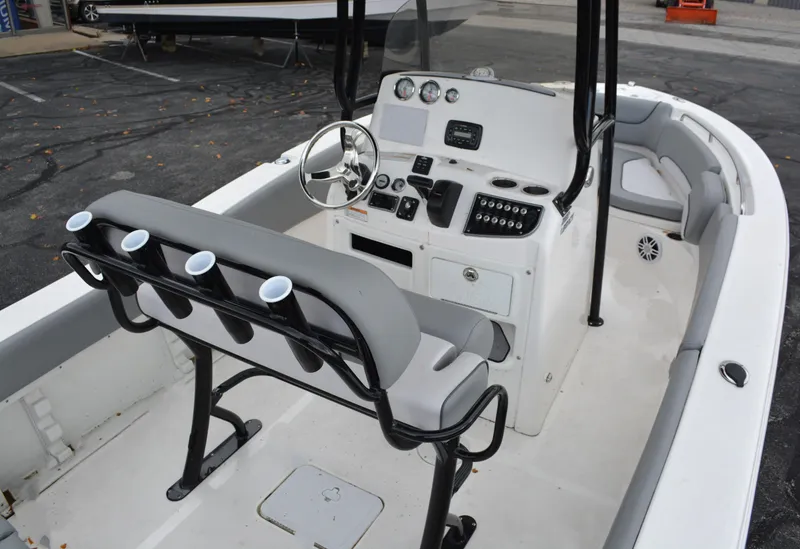 Slide: The Image of 2023 NauticStar 2102 Legacy boat interior with steering console and seating. - 6
