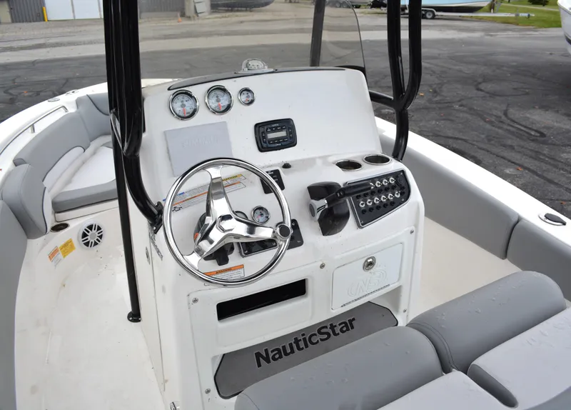 Slide: The Image of 2023 NauticStar 2102 Legacy boat dashboard with steering wheel and controls. - 8