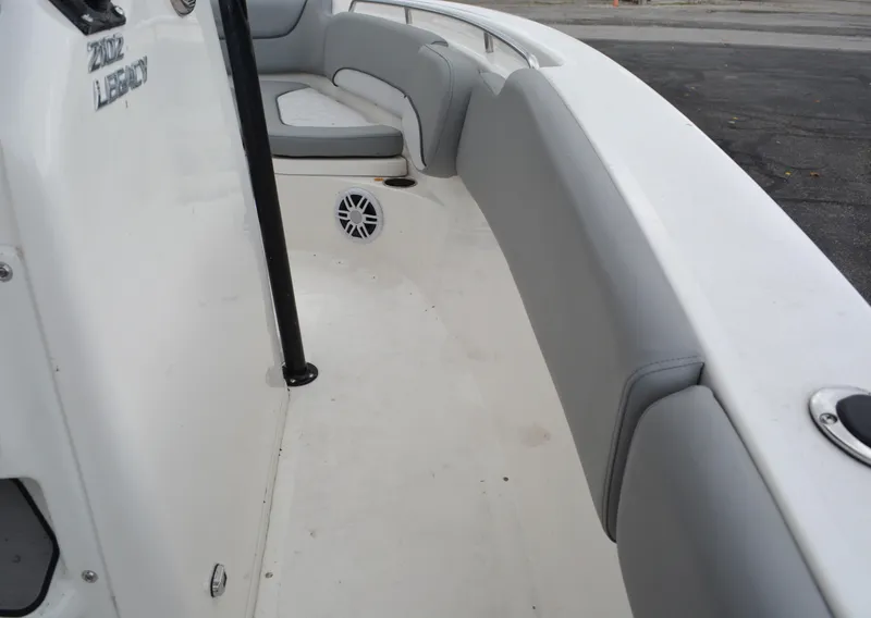 Slide: The Image of 2023 NauticStar 2102 Legacy boat interior with cushioned seating and speaker. - 9