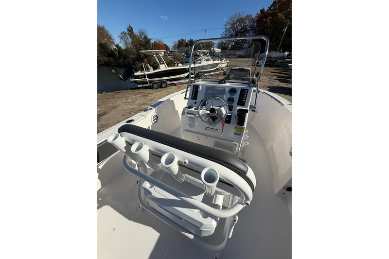 Slide: The Image of 2022 Robalo R180 Center Console boat interior with steering wheel and rod holders. - 16