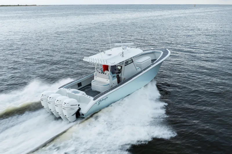 Slide: The Image of 2018 Yellowfin 39 Offshore boat cruising on open water, featuring four powerful engines. - 15