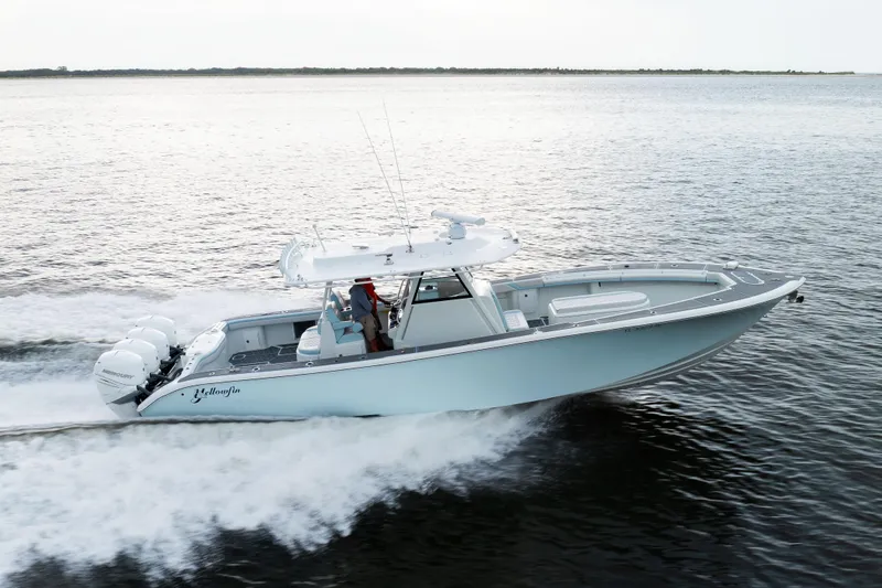 Slide: The Image of 2018 Yellowfin 39 Offshore boat cruising on open water, side view. - 16