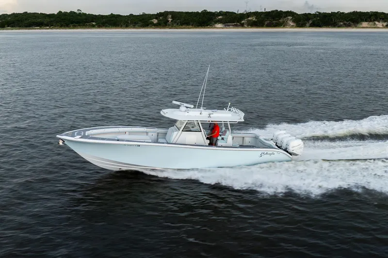 Slide: The Image of 2018 Yellowfin 39 Offshore boat cruising on open water, side view. - 19