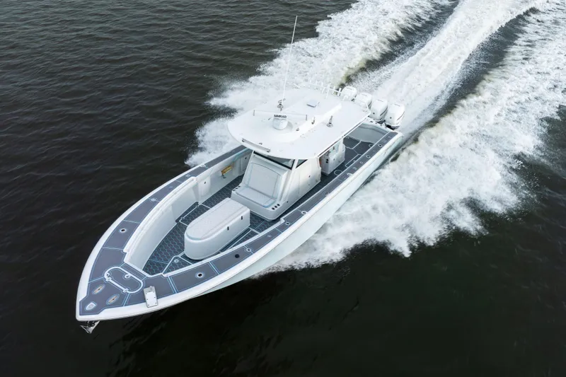 Slide: The Image of 2018 Yellowfin 39 Offshore boat cruising on open water, aerial view. - 20